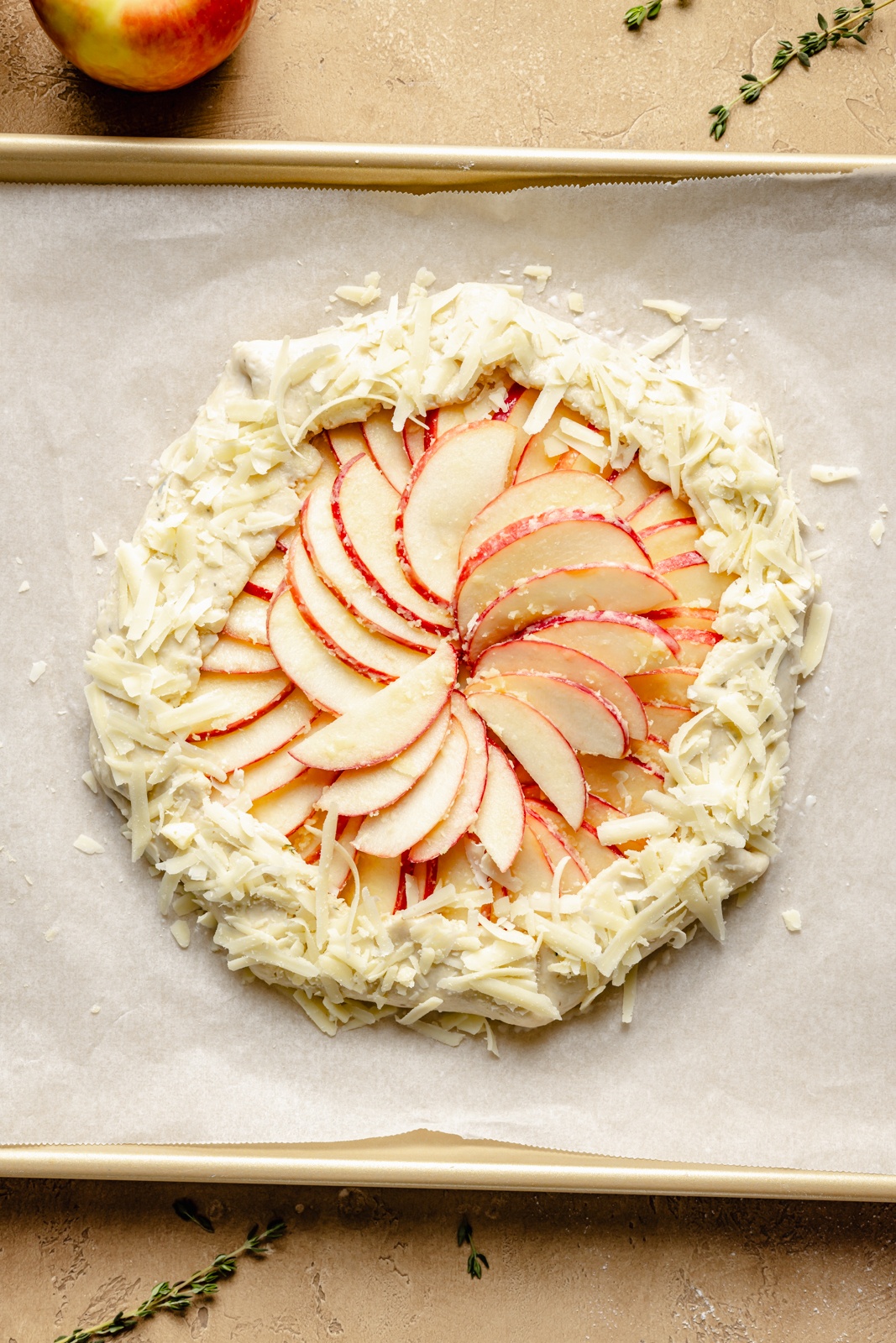 unbaked apple cheddar galette on a baking sheet