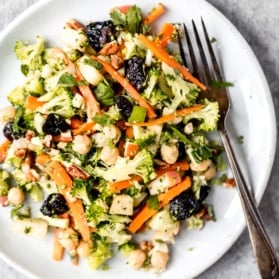 apple broccoli salad on a plate with a fork