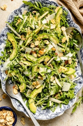 arugula pear salad with avocado on a platter