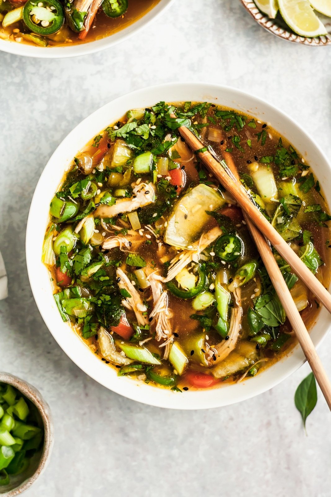 asian chicken soup in a bowl with chopsticks