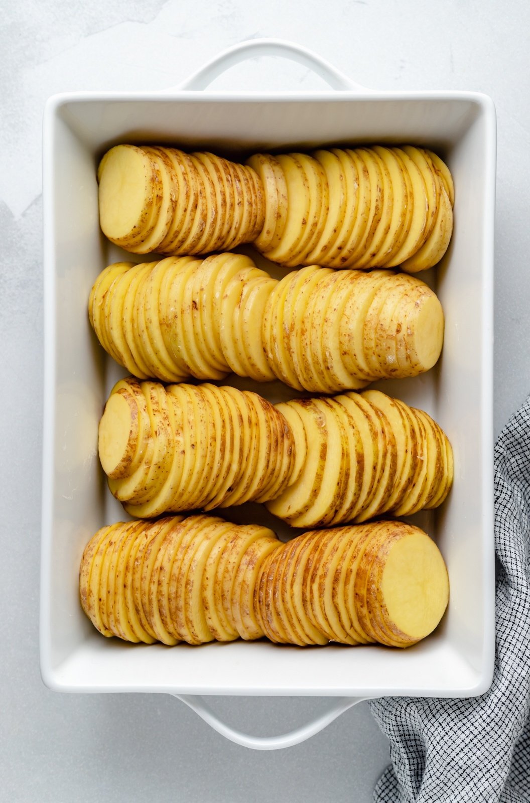 sliced potatoes in a baking dish