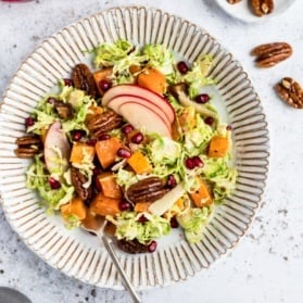 butternut squash brussels sprouts caesar salad on a plate