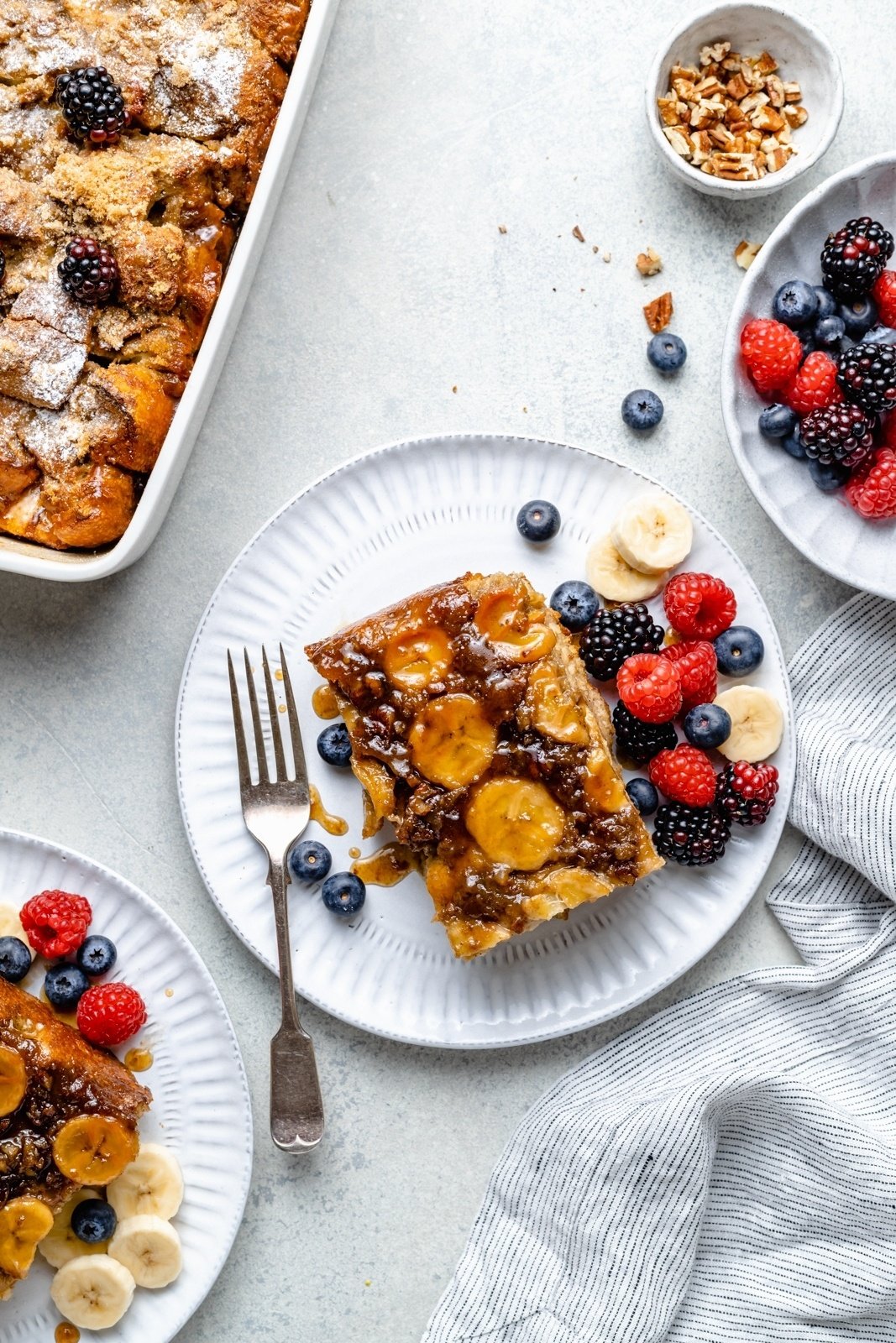 slice of banana french toast bake on a plate with berries