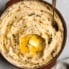 slow cooker mashed potatoes with butter in a bowl