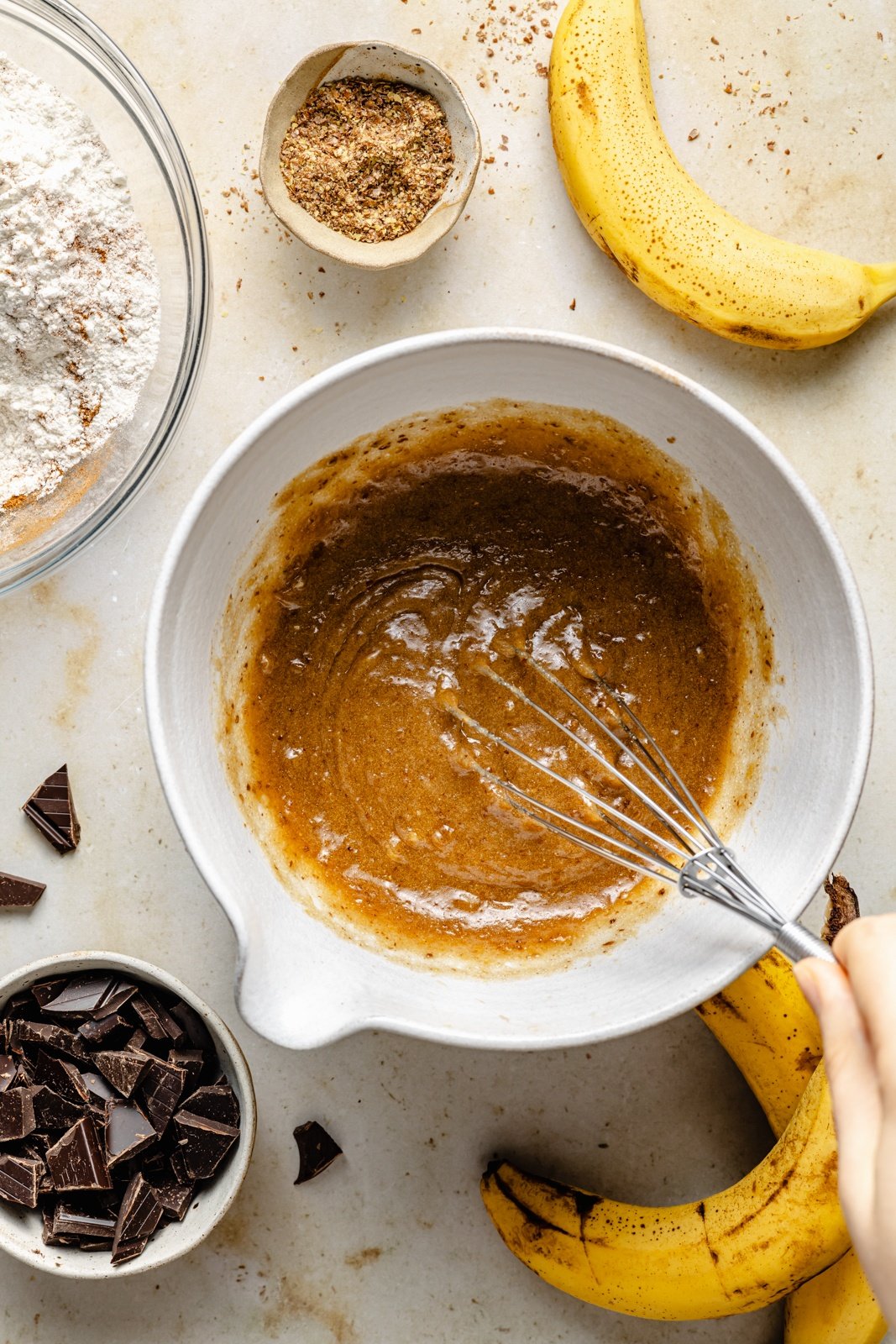 mixing dough for banana chocolate chip cookies in a bowl