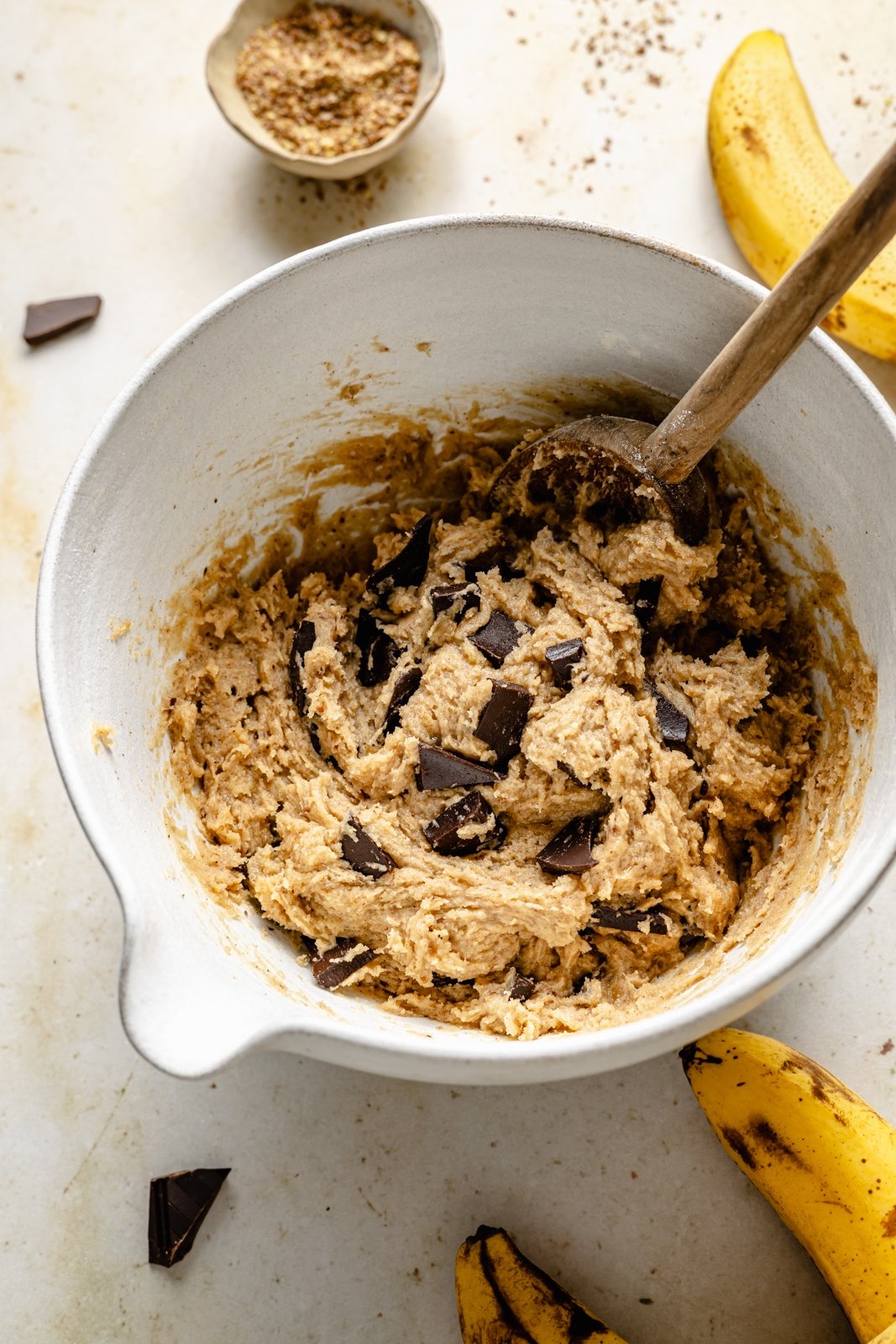 mixing dough for brown butter banana cookies with chocolate chunks