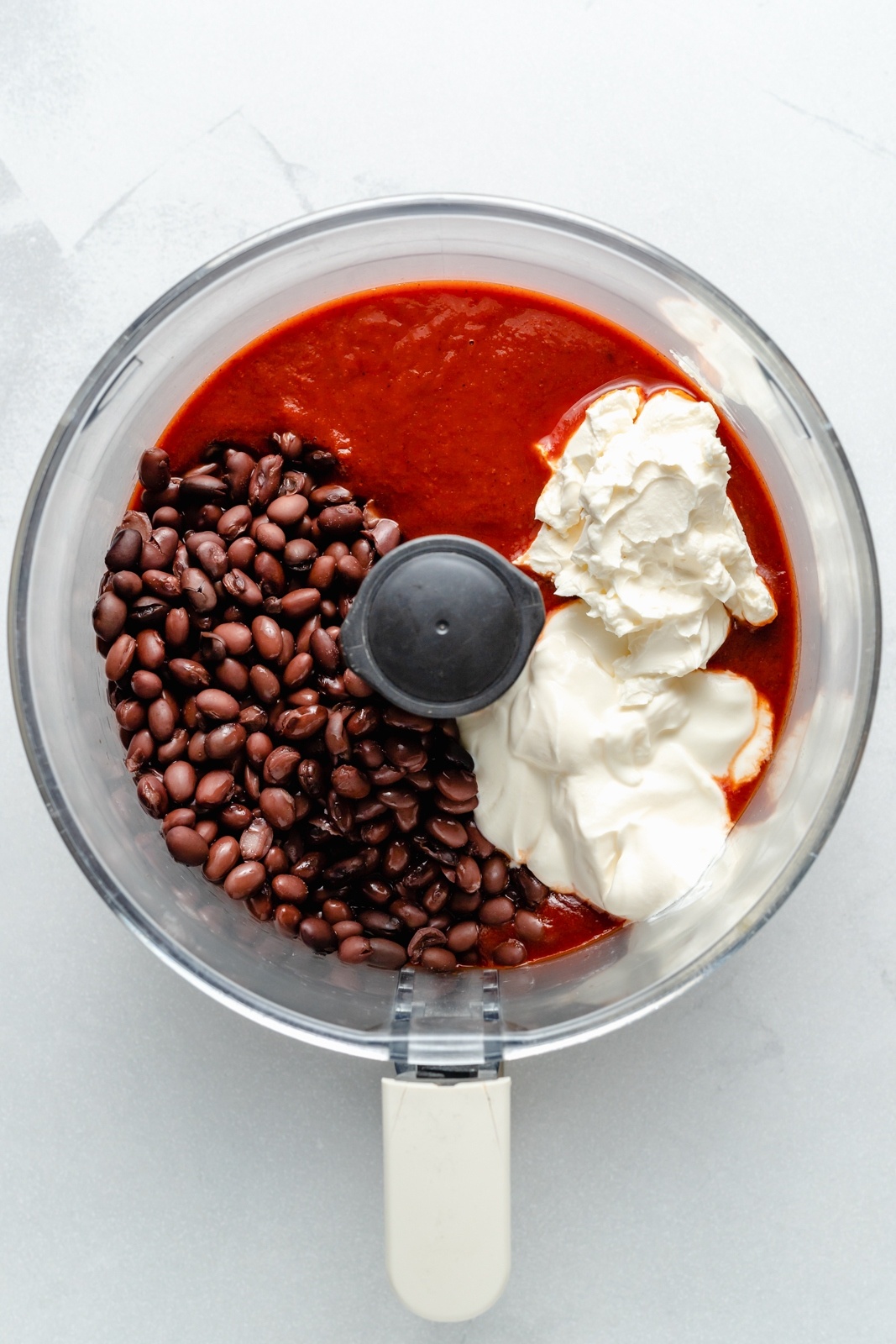 ingredients for enchilada bean dip in a food processor