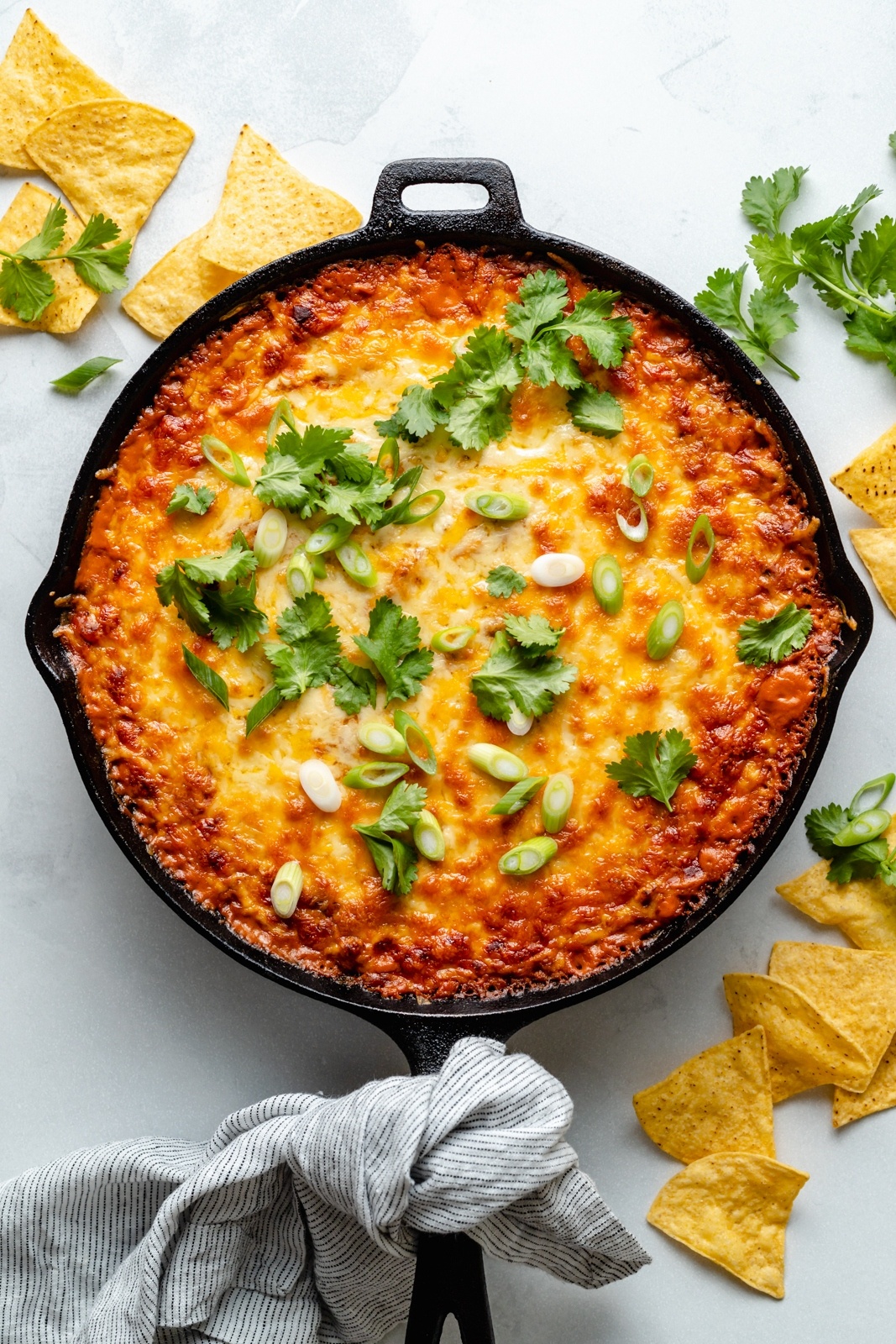 cheesy chicken enchilada dip in a skillet