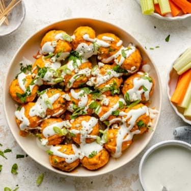 buffalo chicken meatballs in a bowl drizzled with bleu cheese dip