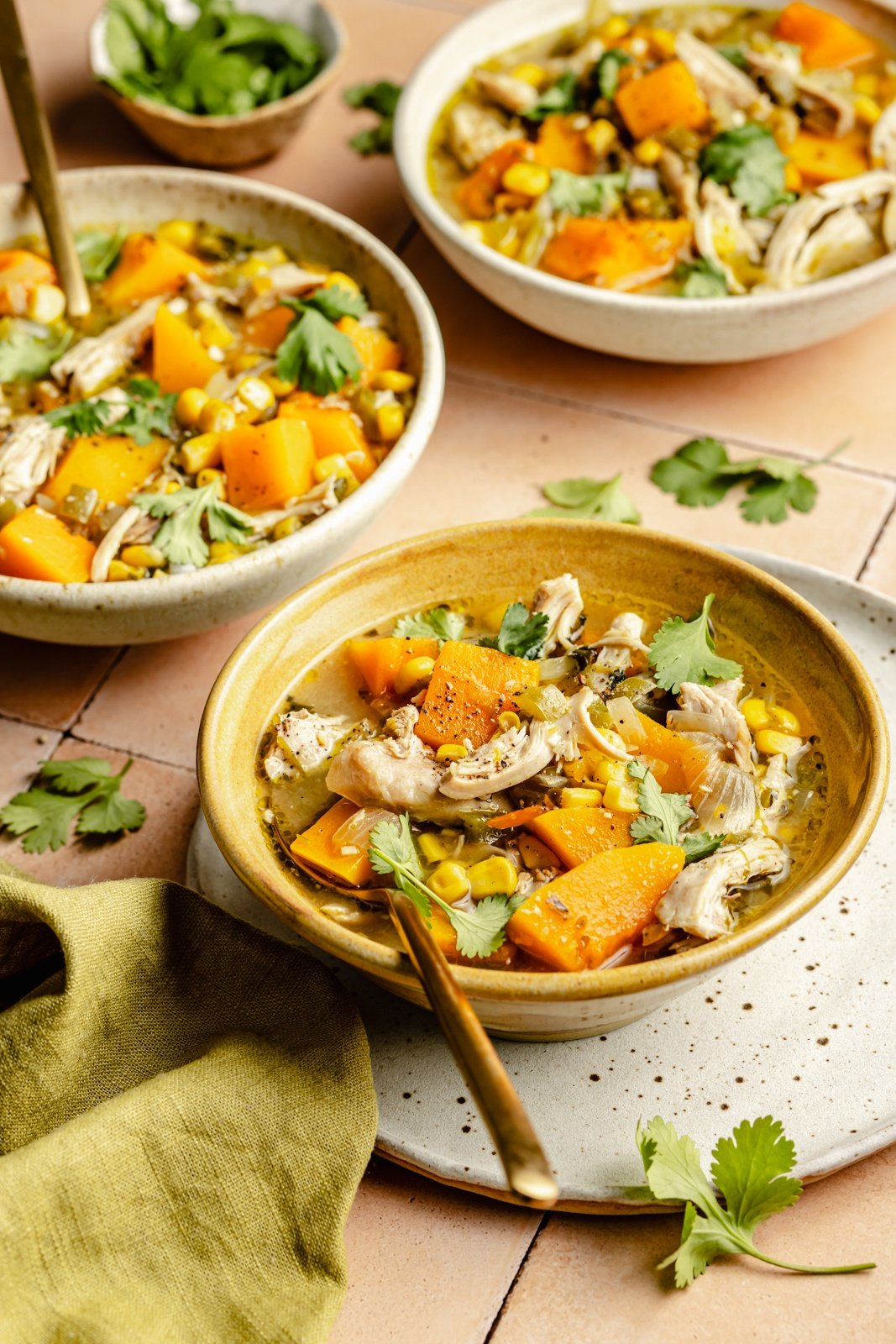 green chile chicken soup in three bowls