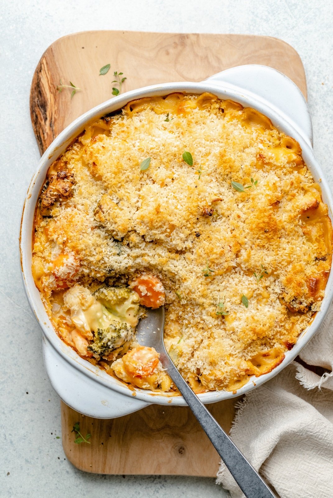 broccoli cauliflower gratin in a baking dish with a spoon