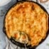 homemade cheddar broccoli leftover turkey pot pie in a skillet with a spoon