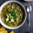 slow cooker chicken chile verde in a bowl topped with avocado