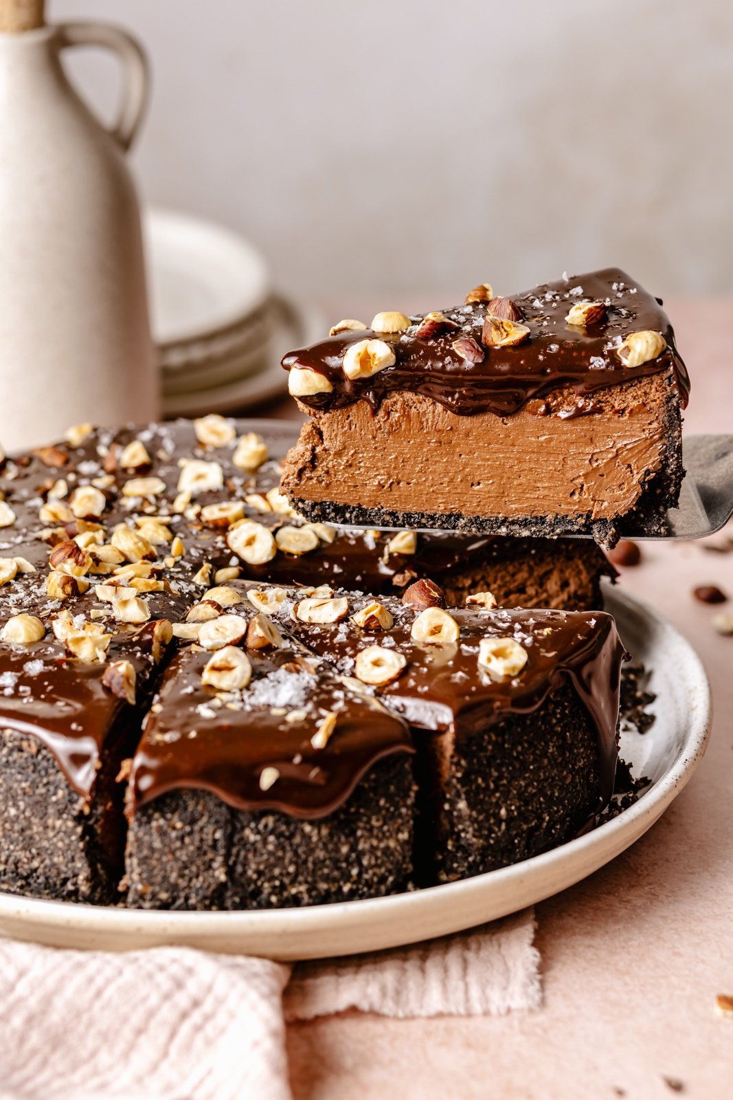 pulling a slice of chocolate cheesecake up from a plate