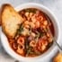 classic minestrone soup in a bowl with garlic bread