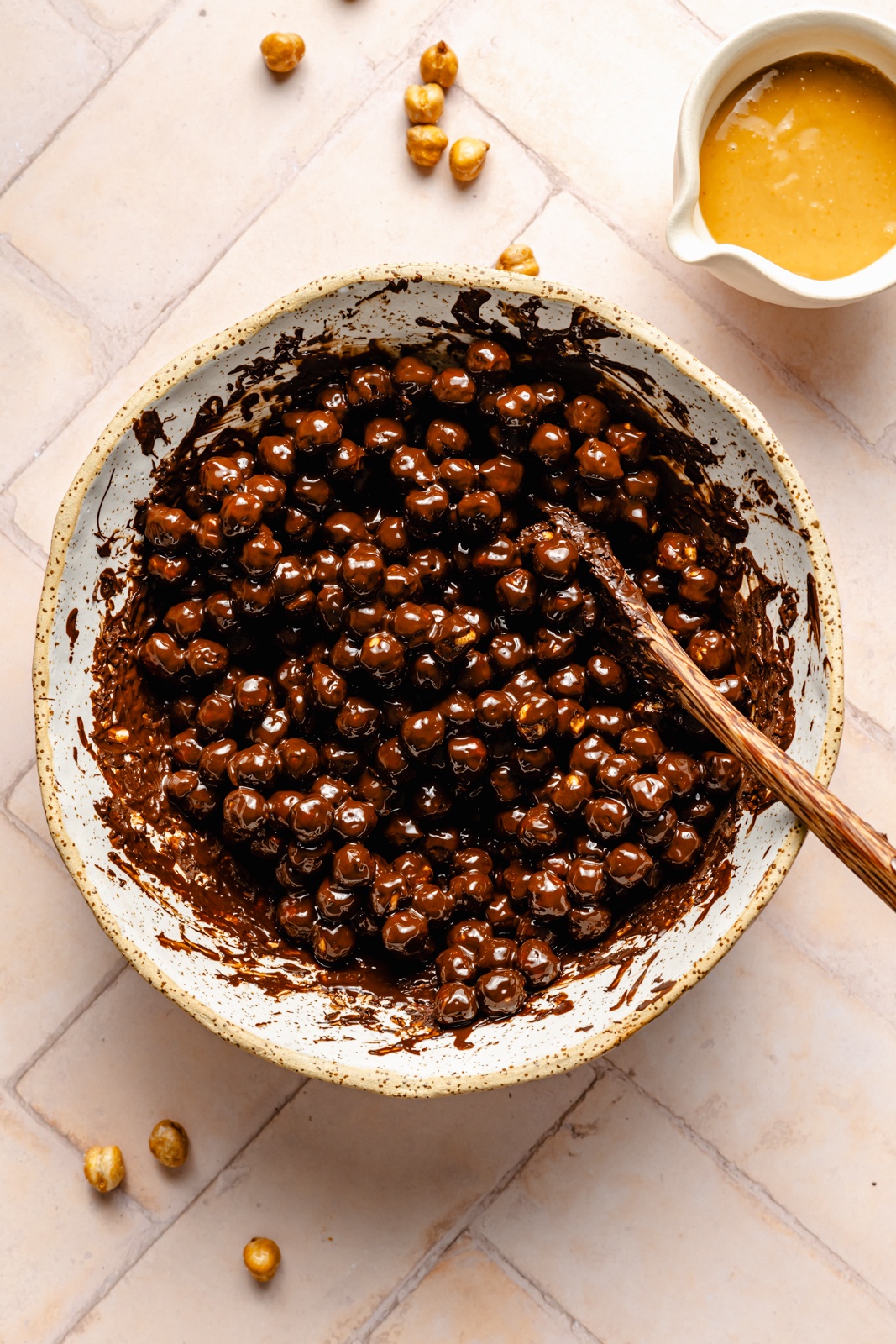 mixing roasted chickpeas with chocolate in a bowl