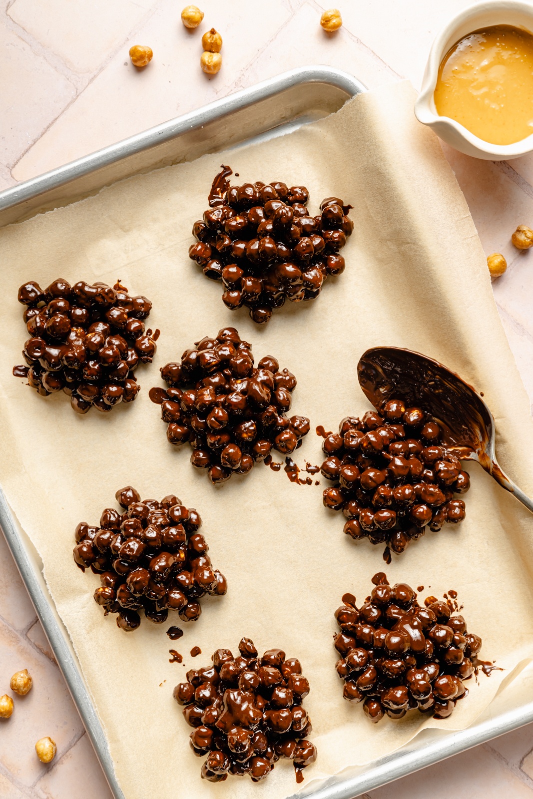 scooping chickpea chocolate clusters onto a baking sheet