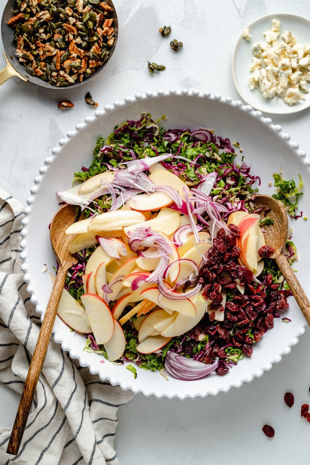 ingredients for a brussels sprouts apple salad in a serving bowl