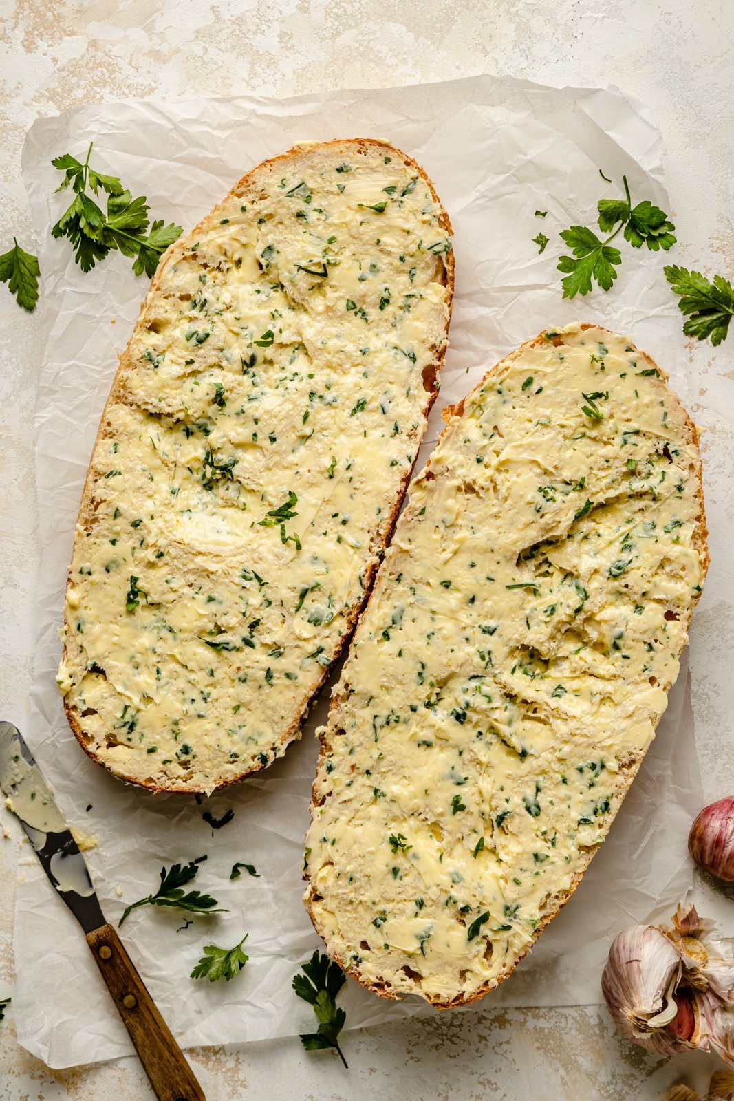 unbaked garlic bread on parchment paper