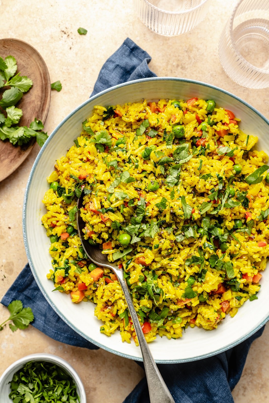 vegetable turmeric rice in a bowl with a spoon