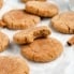 gluten free snickerdoodles on parchment paper with a bite taken out