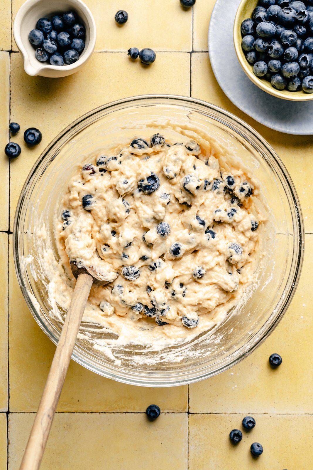 mixing batter for blueberry buttermilk pancakes in a bowl