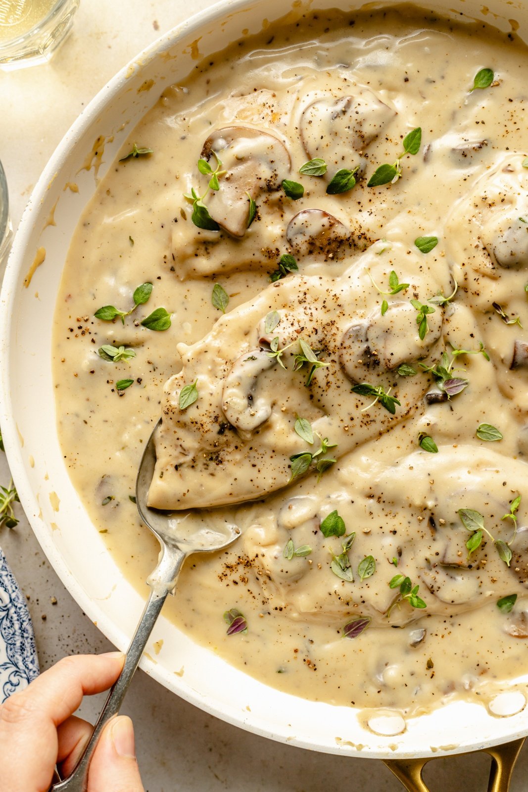 spooning up skillet chicken with mushroom gravy