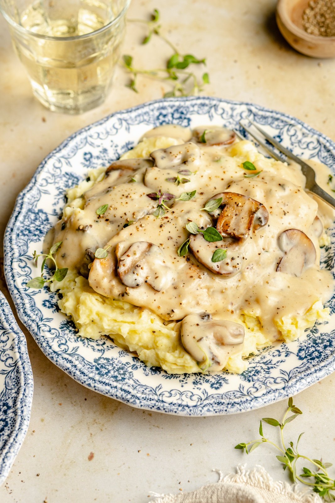 one pan chicken with mushroom gravy on a plate with mashed potatoes