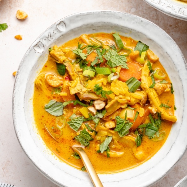 ginger chicken soup in a bowl with herbs