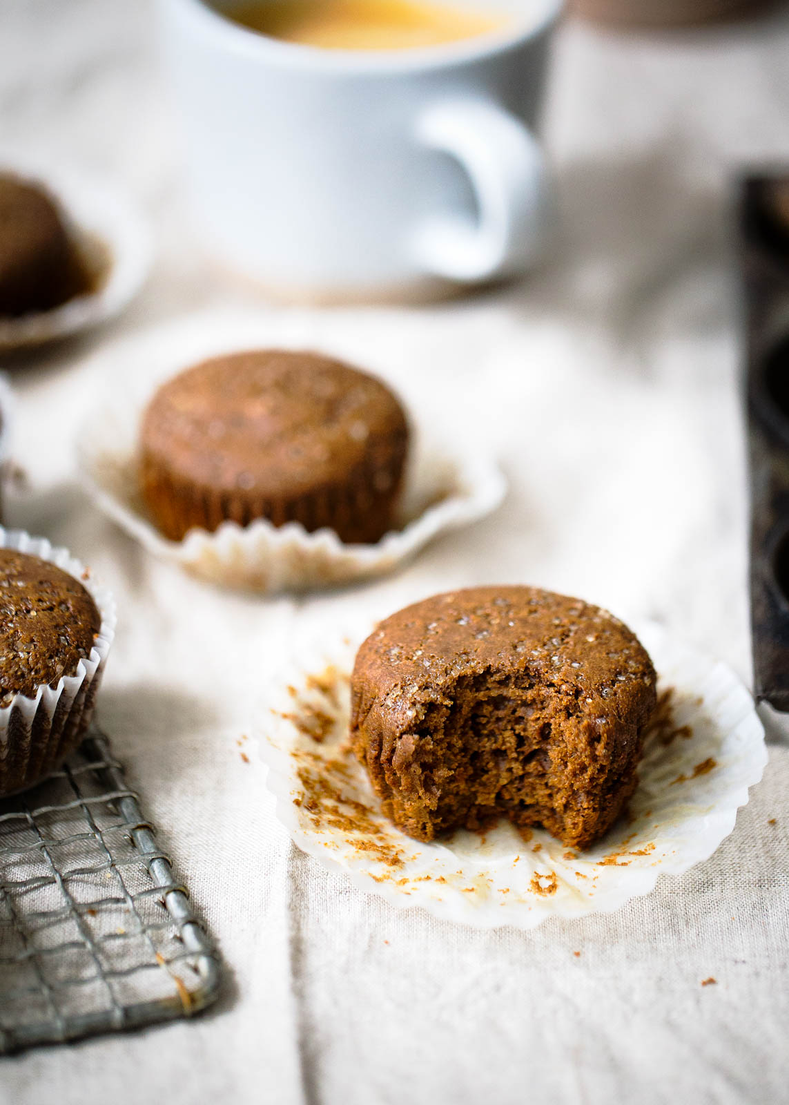 easy, healthy gingerbread muffins on a linen with a bite taken out