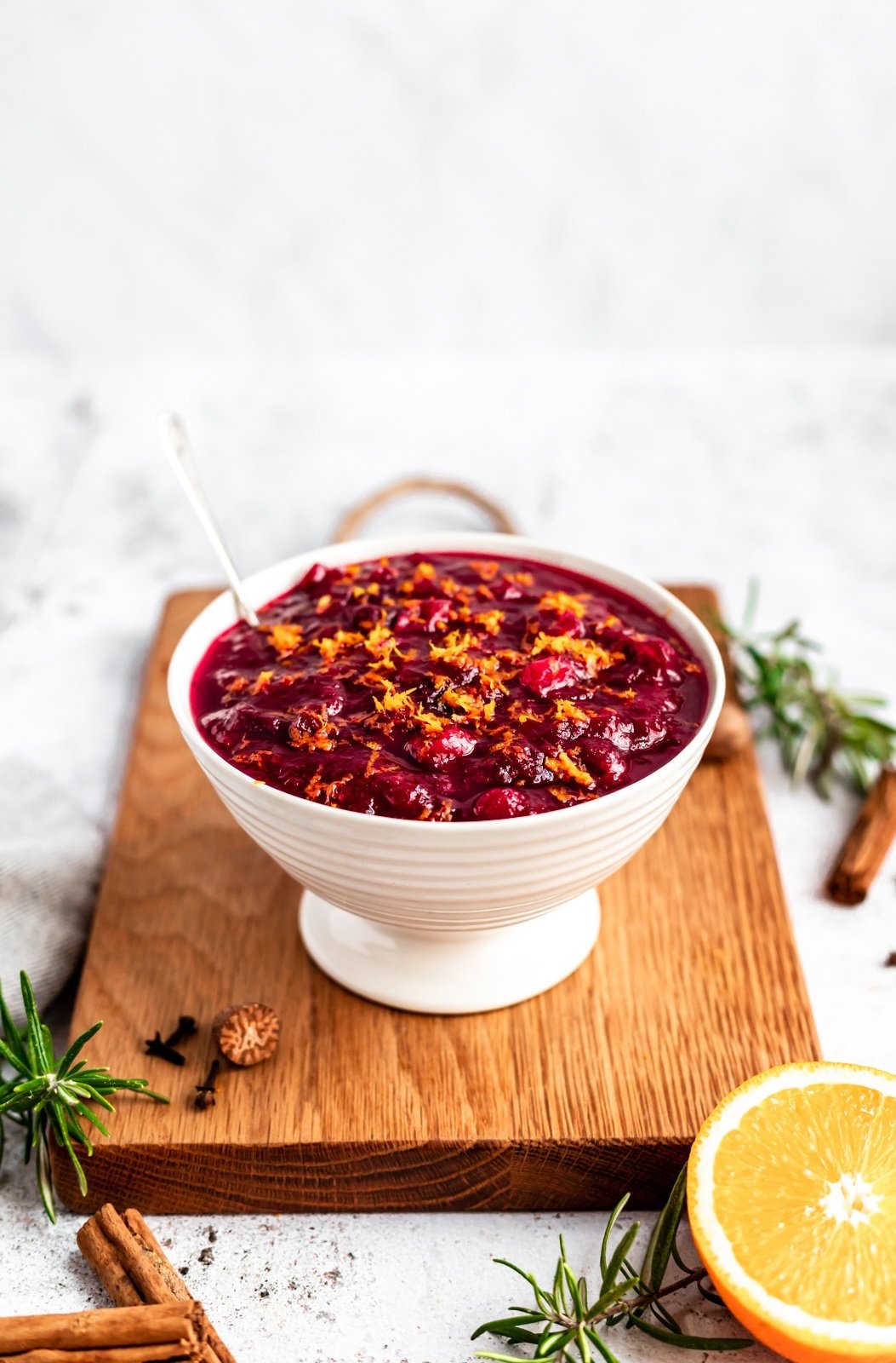 healthy cranberry sauce in a bowl on a cutting board