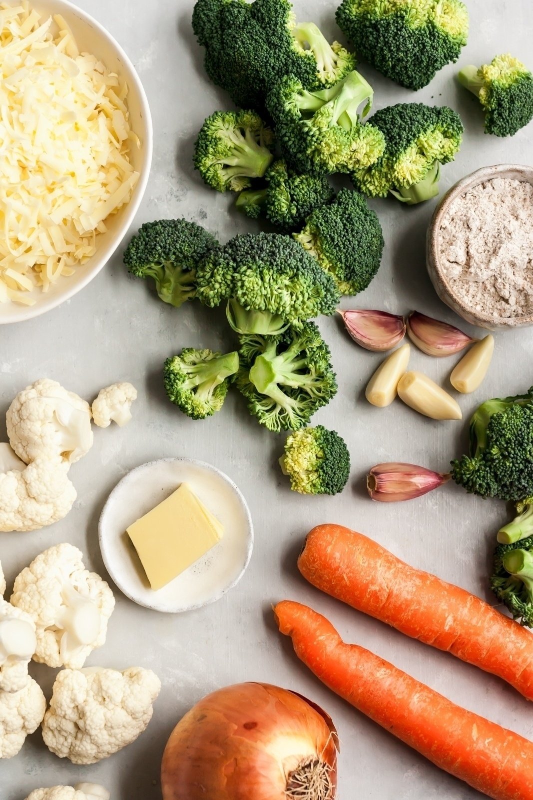 healthy broccoli cheddar soup ingredients on a board