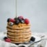 stack of protein pancakes topped with berries