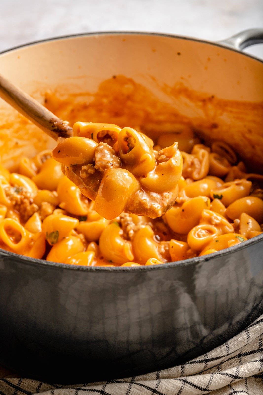 scooping up homemade hamburger helper from a pot