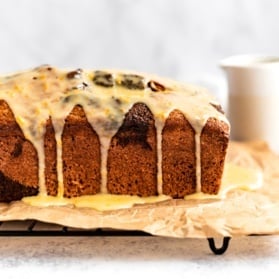 orange gingerbread loaf with orange icing on a wire rack