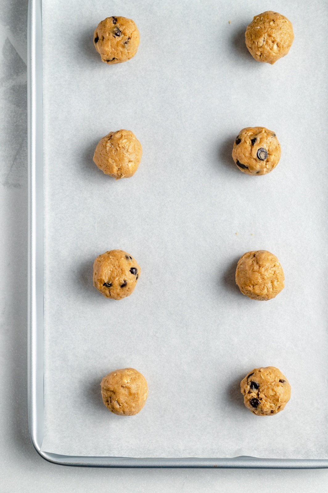 unbaked peanut butter oatmeal cookies on a baking sheet