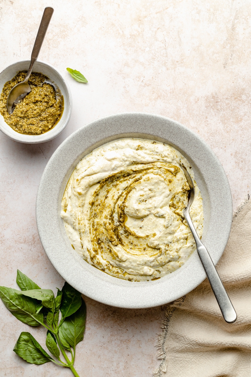 mixing ricotta and pesto for chicken lasagna roll ups