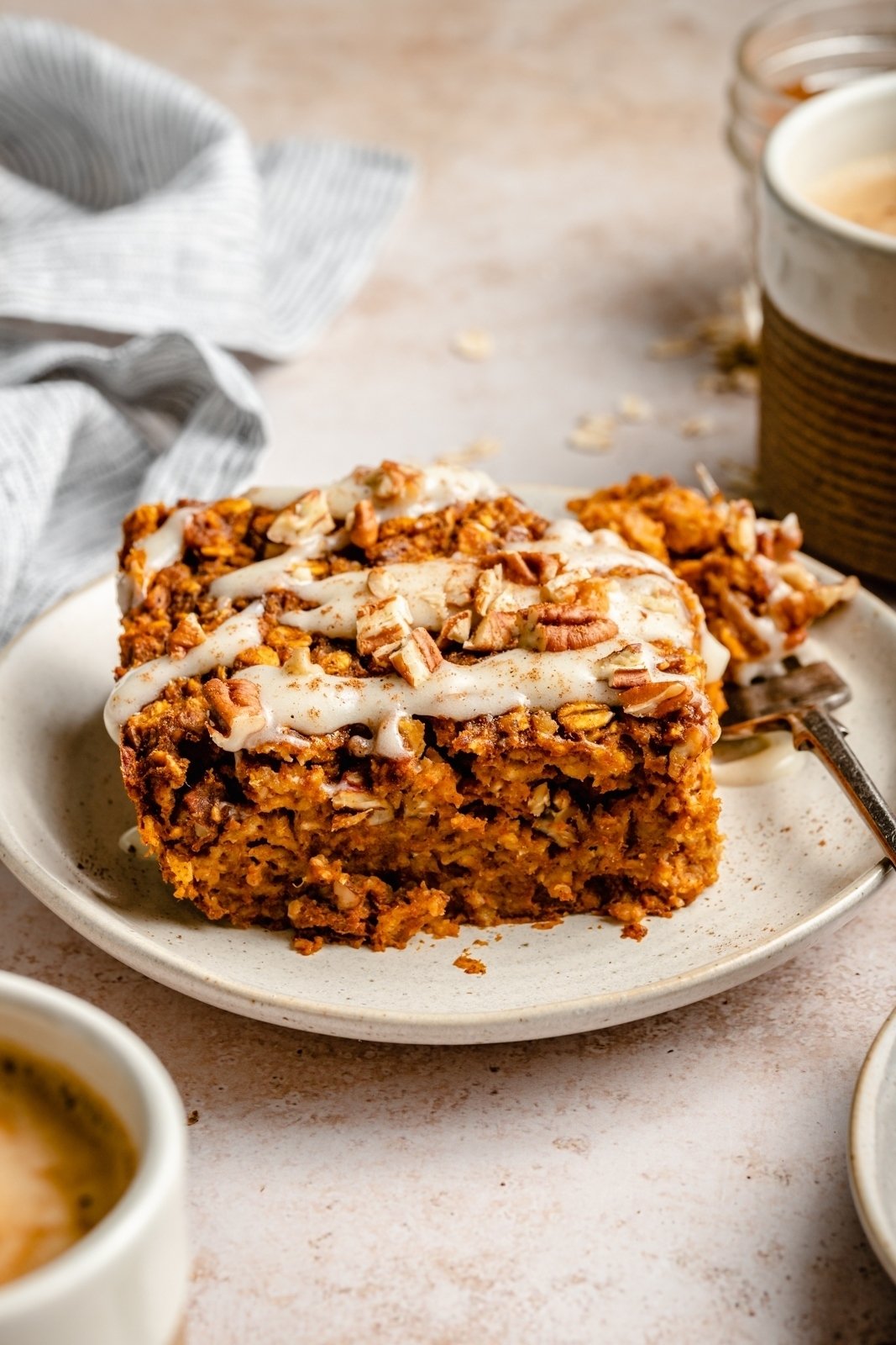 slice of pumpkin oatmeal bake with glaze on a plate