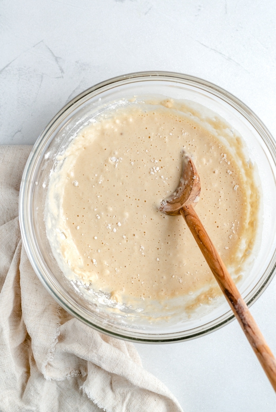 brown butter pancake batter in a bowl with a wooden spoon