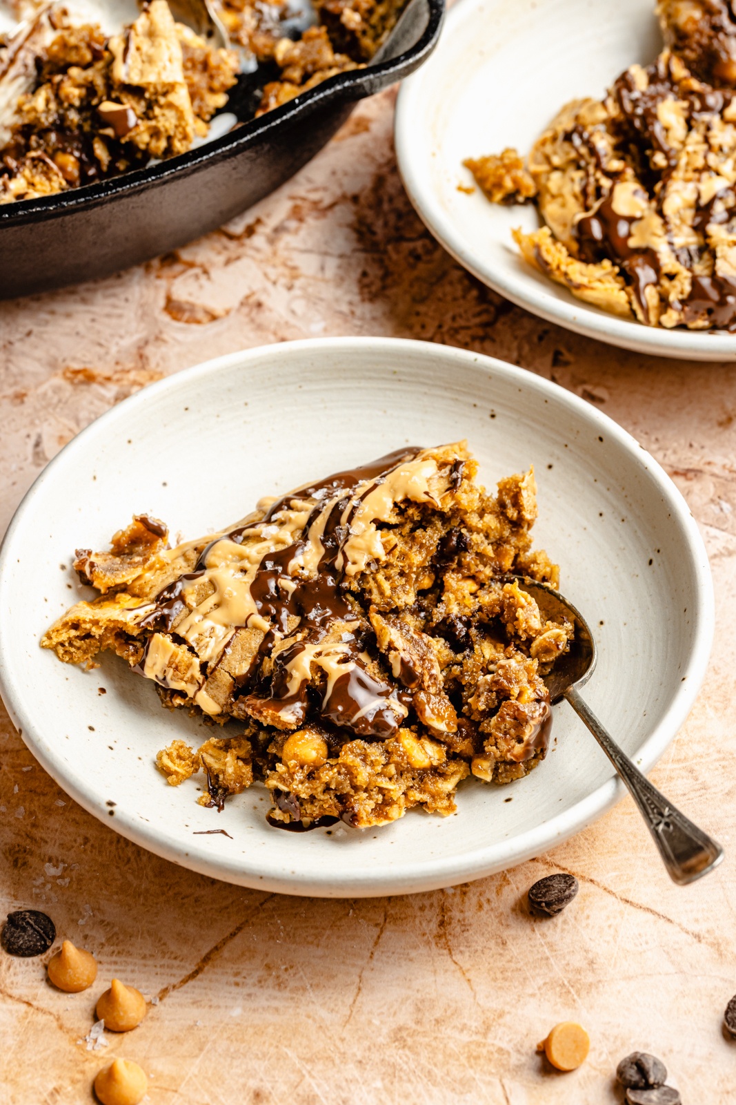 scoop from a tahini butterscotch cookie skillet in a bowl