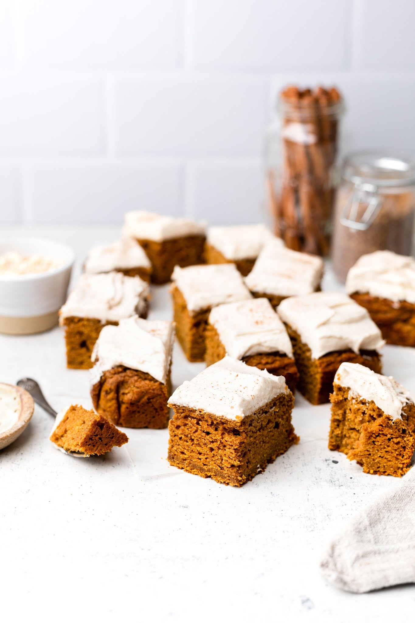 healthy pumpkin cake with frosting cut into squares