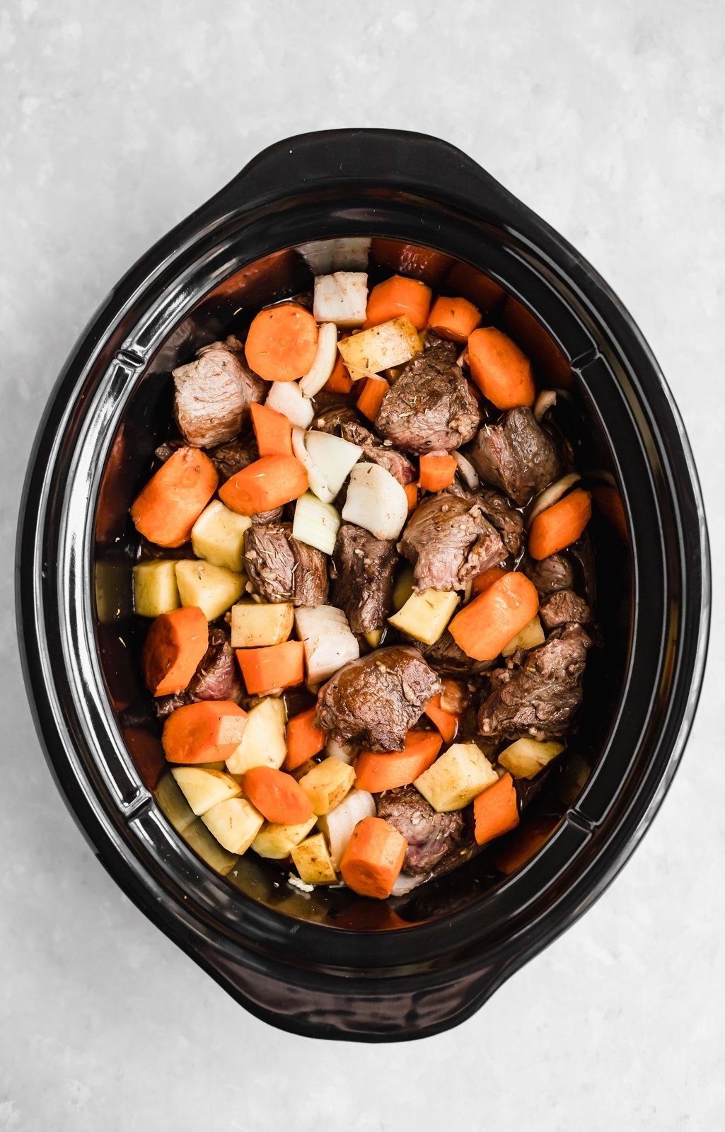 beef stew ingredients in a slow cooker