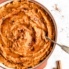 mashed sweet potatoes in a serving dish with a spoon