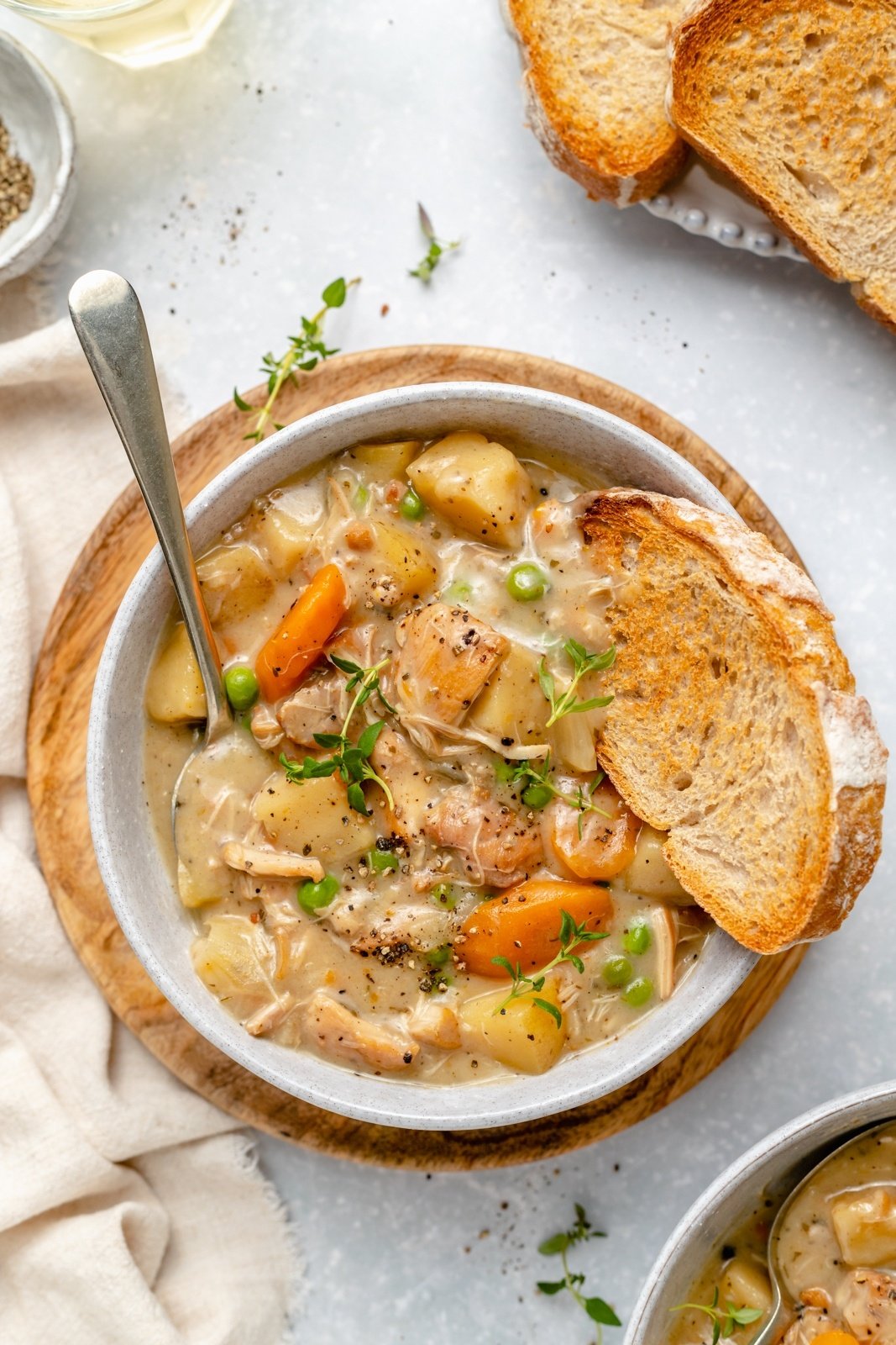 white wine turkey stew in a bowl with a piece of bread