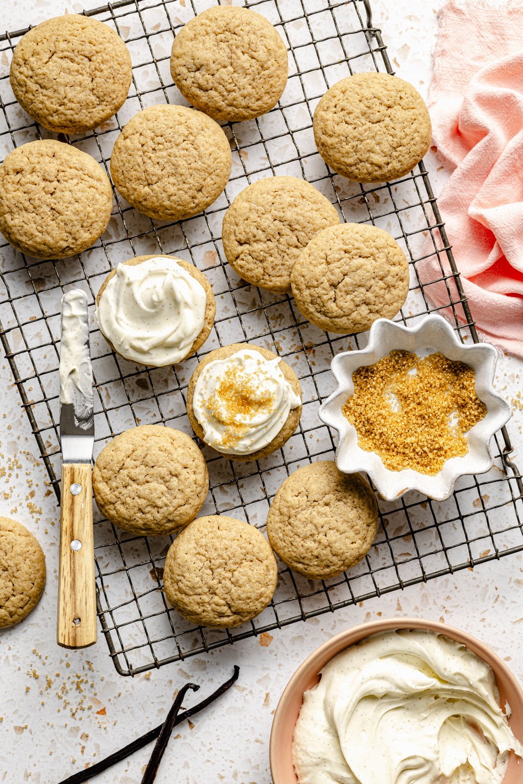 topping chai sugar cookies with vanilla frosting on a wire rack