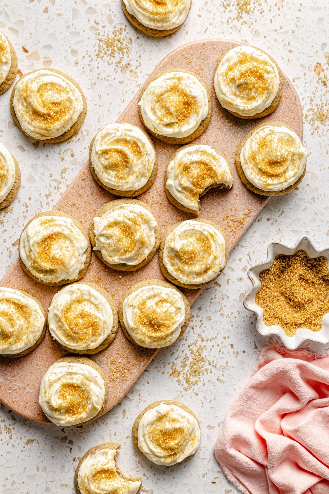 chai sugar cookies with vanilla bean frosting on a serving board