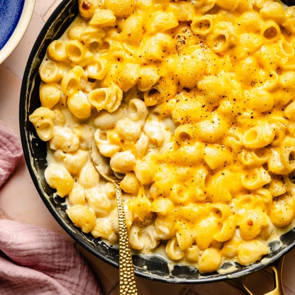 stove-top mac and cheese in a skillet with a spoon