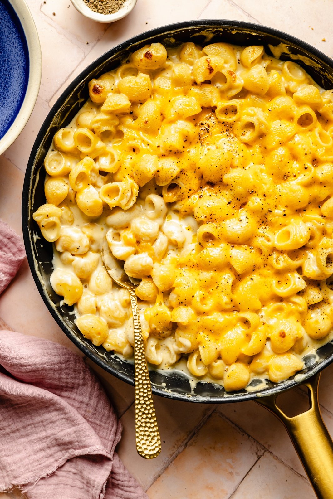 stove-top mac and cheese in a skillet with a spoon