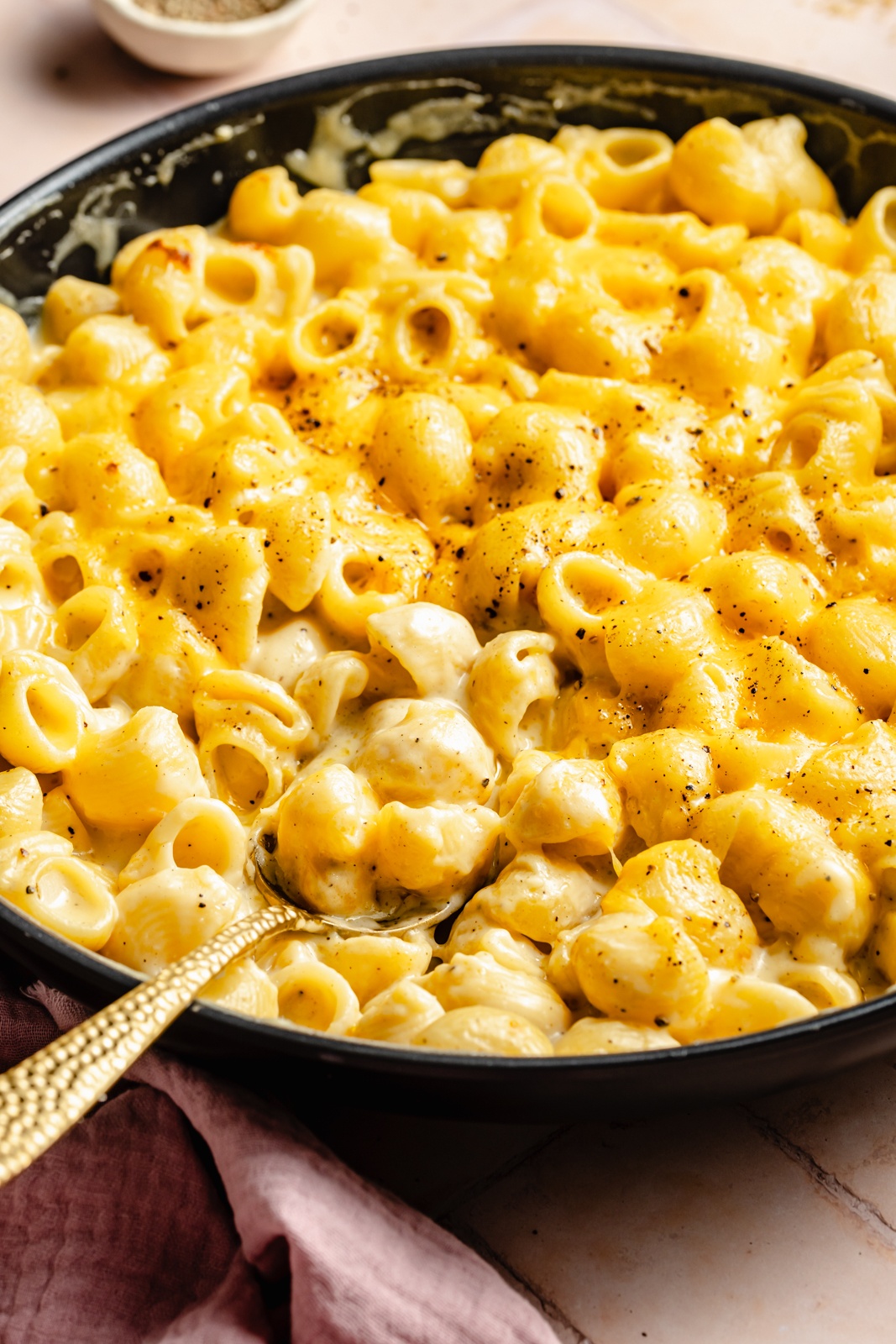 stove-top mac and cheese in a skillet with a spoon