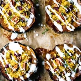 stuffed acorn squash on a baking sheet